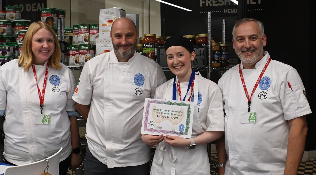 Grace Dugan holding her winner's certificate with judges at the Eat Wild Young Chef competition